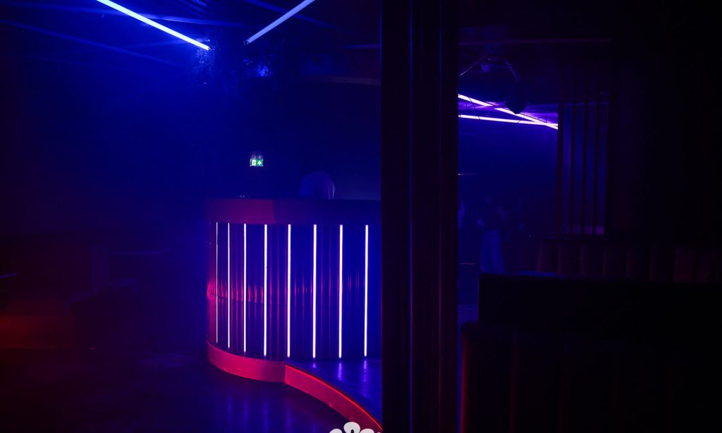 The curved bar counter at Cabo picked out in vertical neon strips.